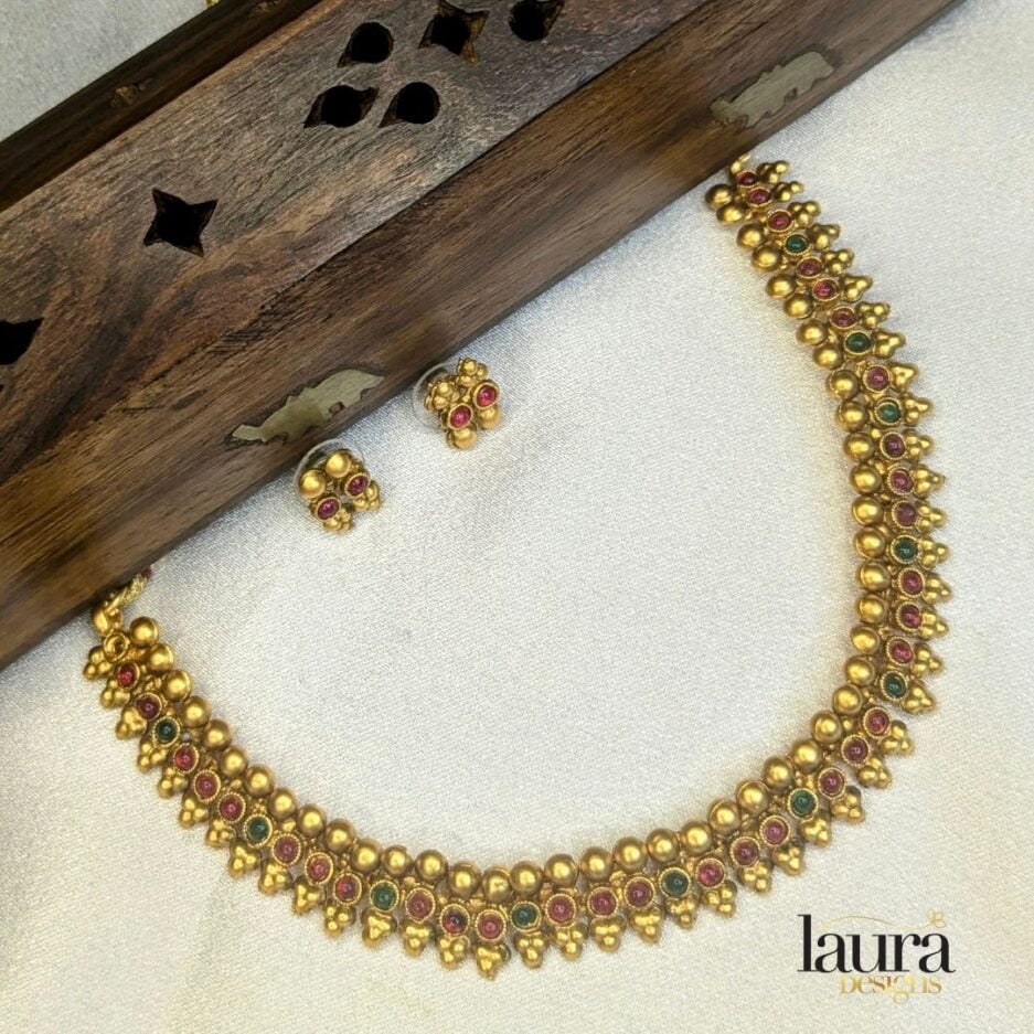 Traditional gold plated necklace set with ruby pink and green stones