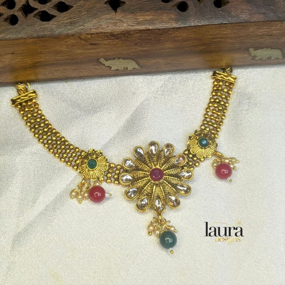 Gold polished traditional neckpiece with ruby pink and green stones