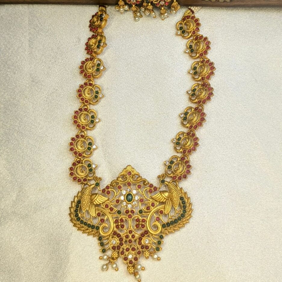 Traditional long necklace with green and pink stones
